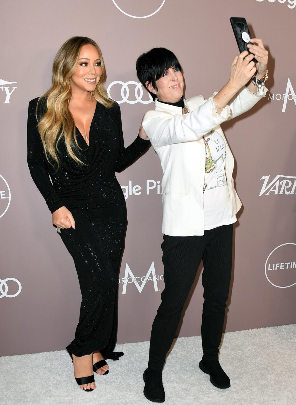 Meanwhile on the Power of Women red carpet, songstresses Mariah Carey and Diane Warren snap a selfie.