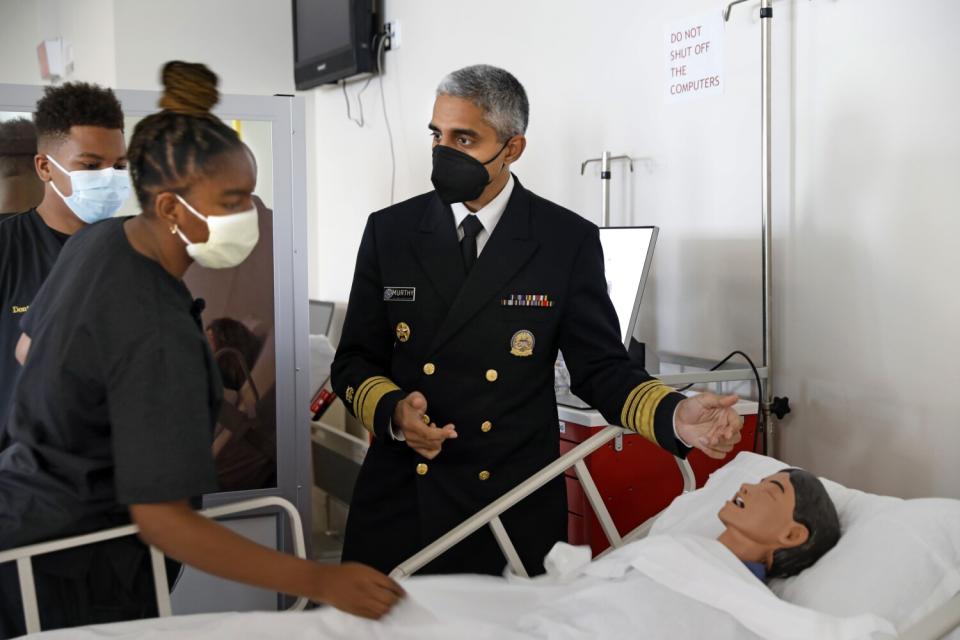 Surgeon General Vivek H. Murthy with senior students before talking to a panel about mental health issues.