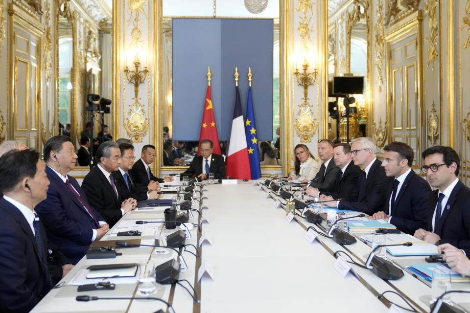 French President Emmanuel Macron, second right, China's President Xi Jinping, second left, and delegates pose during a working session at the Elysee Palace, Monday, May 6, 2024 in Paris. China's President Xi Jinping is in France for a two-day state visit that is expected to focus both on trade disputes and diplomatic efforts to convince Beijing to use its influence to move Russia toward ending the war in Ukraine. (AP Photo/Thibault Camus, Pool)