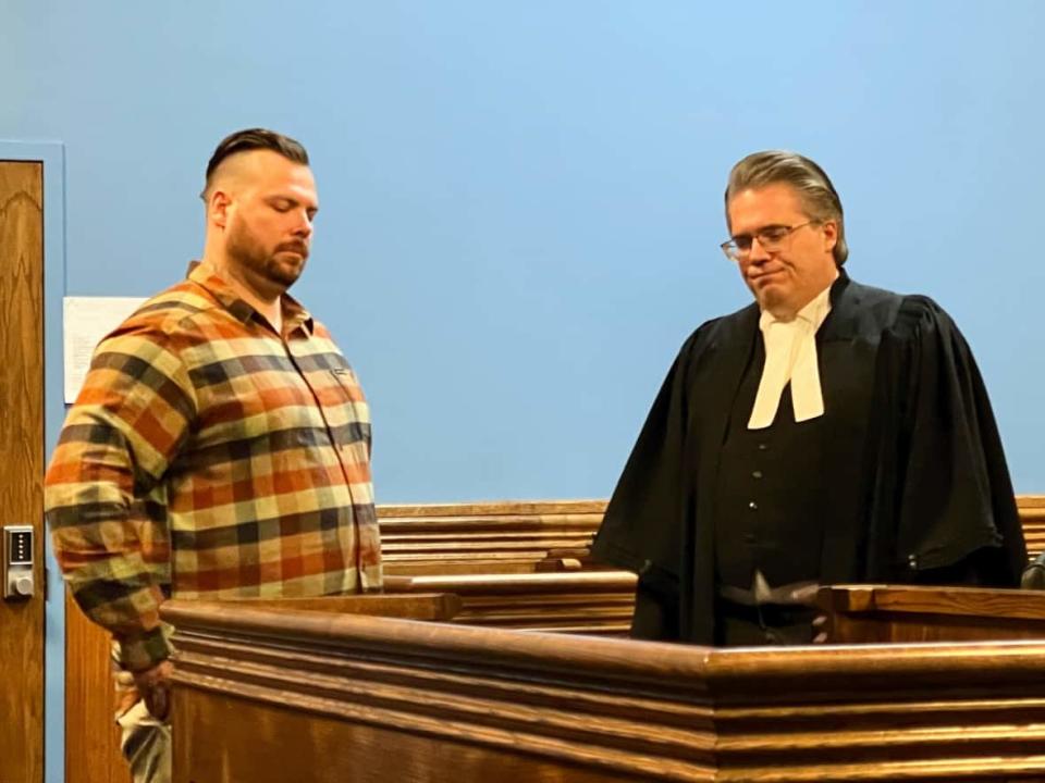 Vincent Ward and defence counsel Mark Gruchy stand in the courtroom on Monday. After a month-long trial, the jury is now in deliberations.  (Heidi Atter/CBC - image credit)