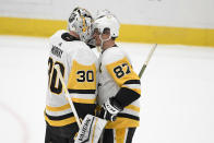 Pittsburgh Penguins goaltender Matt Murray (30) and center Sidney Crosby (87) celebrate after an NHL hockey game against the Washington Capitals, Sunday, Feb. 2, 2020, in Washington. (AP Photo/Nick Wass)