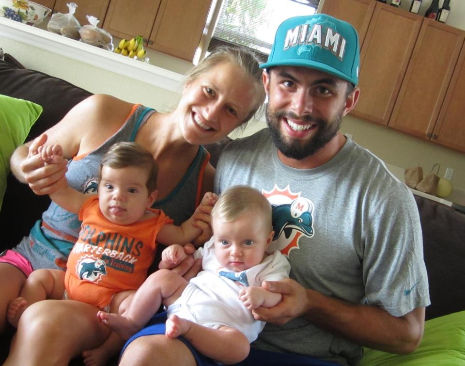 This September 2012 photo provided by Laura Radocaj shows her and her husband Marco Radocaj with their twins, Rudy, in orange, and Ryan, in white, in Vero Beach, Fla. Marco Radocaj, 28, is an example of Gen Y/Millennial fathers who are not just changing the occasional diaper but are committed to a full partnership with their wives in childrearing and running the household. (AP Photo/Laura Radocaj)