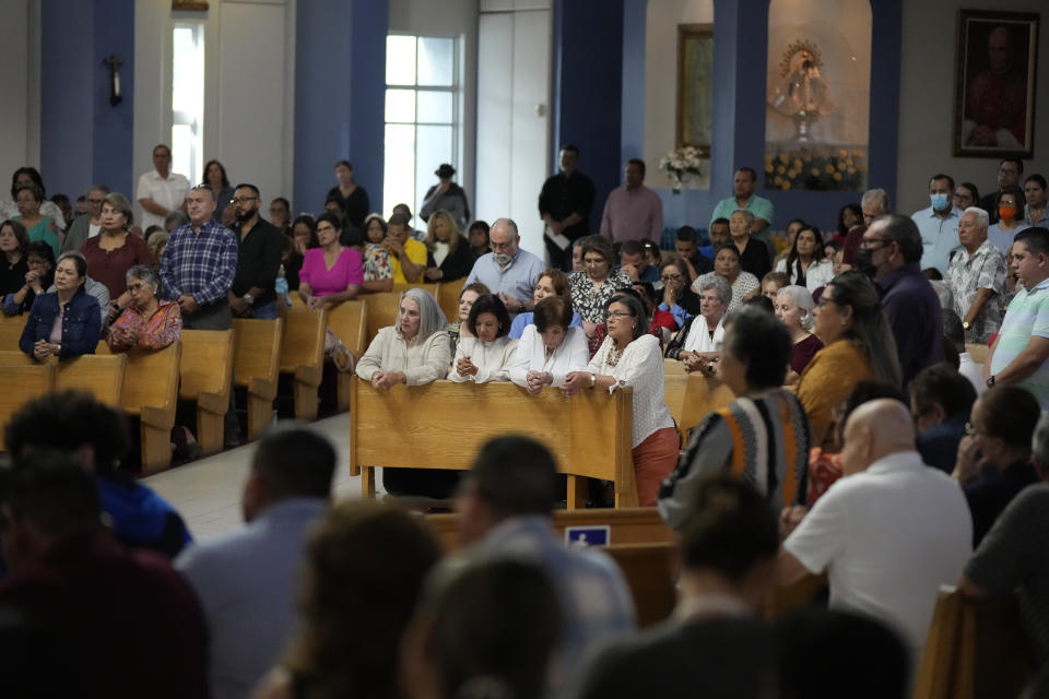 Parishioners attend Mass at St. Agatha Catholic Church, which has become the spiritual home of the growing Nicaraguan diaspora, Sunday, Nov. 5, 2023, in Miami. For the auxiliary bishop of Managua, his fellow priests and many worshippers who have had to flee or were exiled from Nicaragua recently, the Sunday afternoon Mass at the Miami parish is not only a way to find solace in community, but also to keep pushing back against the Ortega regime's violent suppression of all critics, including many Catholic leaders. (AP Photo/Rebecca Blackwell)