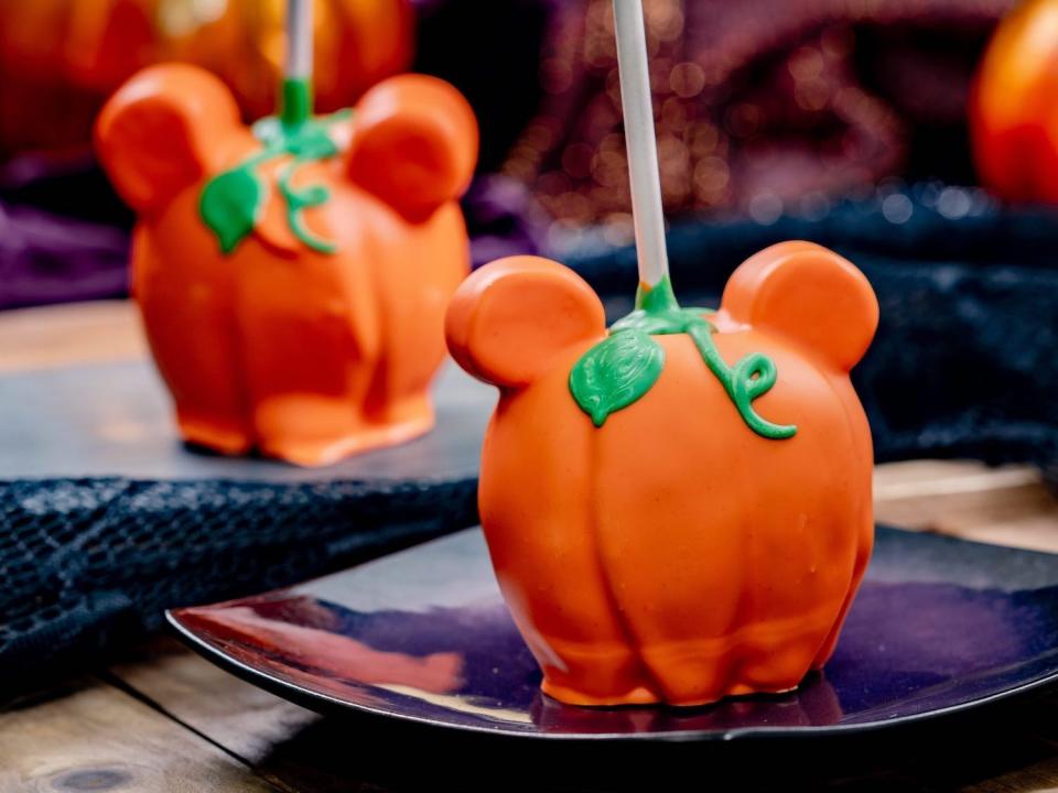 A Mickey-shaped pumpkin candy apple at Disneyland in 2022.