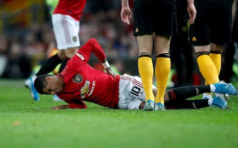 Manchester United's Marcus Rashford lies in pain after picking up an injury. - Credit: PA