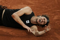 Germany's Alexander Zverev grimaces in pain after twisting his ankle during the semifinal match against Spain's Rafael Nadal at the French Open tennis tournament in Roland Garros stadium in Paris, France, Friday, June 3, 2022. (AP Photo/Thibault Camus)