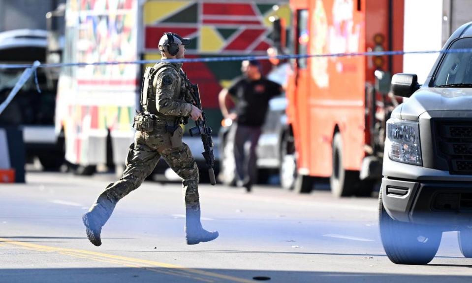 An FBI agent runs toward the west end of Union Station after a shooting following the Kansas City Chiefs Super Bowl LVIII victory parade on Wednesday, Feb. 14, 2024, in Kansas City.