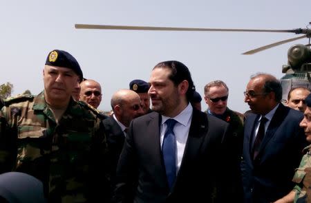 FILE PHOTO: Lebanese Prime Minister Saad al-Hariri arrives with Army Commander General Joseph Aoun (L) at the United Nations Interim Force in Lebanon (UNIFIL) headquarters in Naqoura, near the Lebanese-Israeli border, southern Lebanon April 21, 2017. REUTERS/Ali Hashisho/File Photo