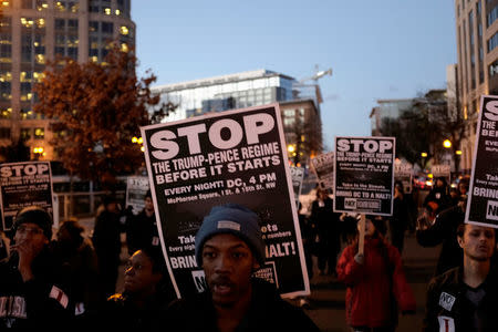 Anti-Trump demonstrators organized by RefuseFascism.org march through the streets of Washington January 18, 2017. REUTERS/James Lawler Duggan