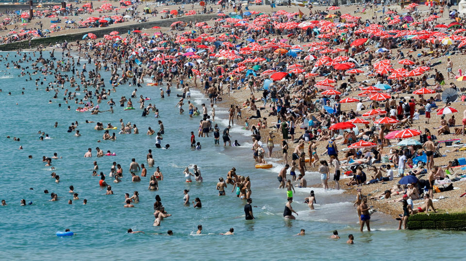 People enjoy the hot weather on Brighton beach, during a heatwave in Brighton, Britain, July 19, 2022. REUTERS/Peter Cziborra