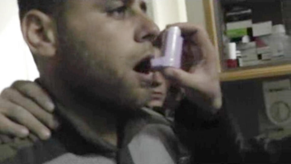 In this Friday, April 11, 2014 image made from amateur video, provided by Shams News Network, a loosely organized anti-Assad group based in and out of Syria that claim not to have any connection to Syrian opposition parties or any other states, and is consistent with independent AP reporting, shows a man being given doses from an inhaler at a hospital room in Kfar Zeita, some 200 kilometers (125 miles) north of Damascus, Syria. Syrian government media and rebel forces said Saturday, April 12, 2014 that poison gas had been used in the village on Friday, injuring scores of people, while blaming each other for the attack. (AP Photo/Shams News Network)