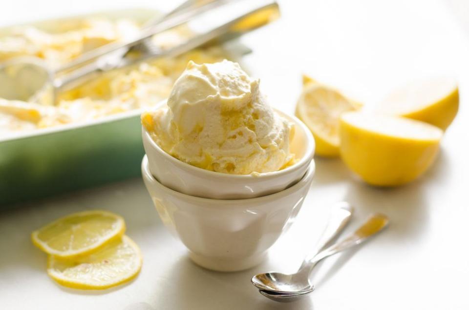 lemon curd ripple ice cream in white bowls stacked