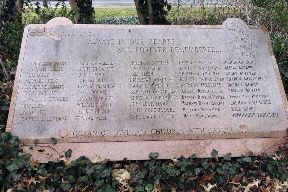 A stone memorial to childhood cancer victims is shown on Feb. 21, 2023. in Toms River, N.J. Many residents of Toms River, where the former Ciba-Geigy chemical plant dumped toxic waste into the Toms River and directly onto the ground, oppose a settlement with the site's current owner, BASF Corp. to restore natural resources at the site as inadequate and ill-advised. (AP Photo/Wayne Parry)