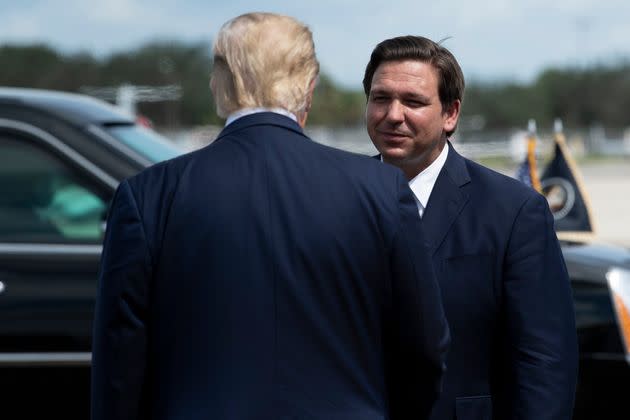 Then-President Donald Trump is greeted by Florida Gov. Ron DeSantis on Oct. 16, 2020, in Fort Myers, Florida. (Photo: BRENDAN SMIALOWSKI via Getty Images)