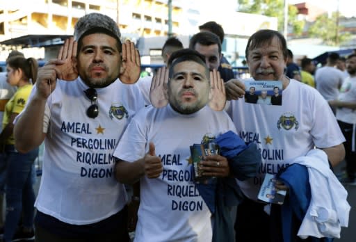 Boca Juniors' fans wear Riquelme masks and t-shirts supporting the Ameal ticket at the game against Argentinos Juniors on November