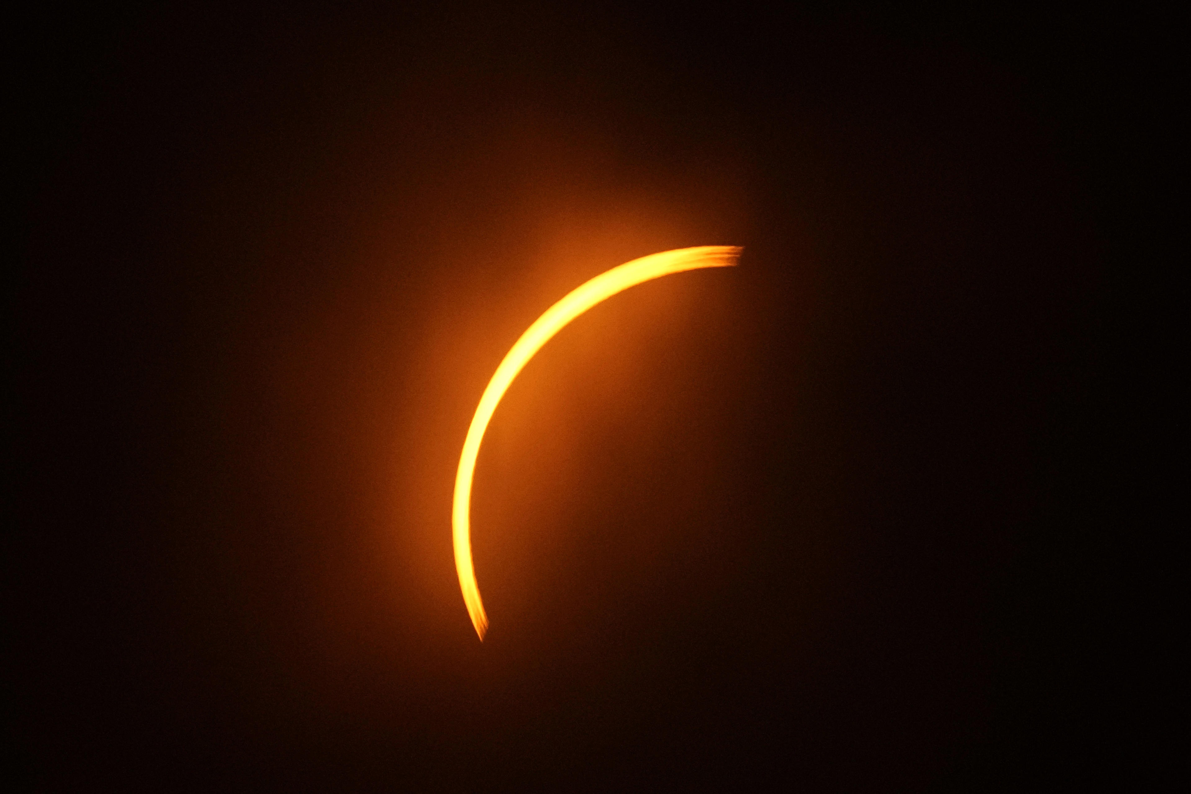 The moon partially covers the sun during a total solar eclipse, as seen from Eagle Pass, Texas.