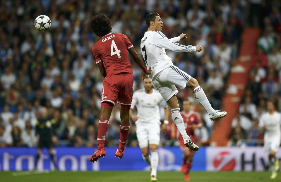 Bayern Munich's Dante and Real Madrid's Ronaldo jump for a high ball during their Champions League semi-final first leg soccer match at Santiago Bernabeu stadium in Madrid