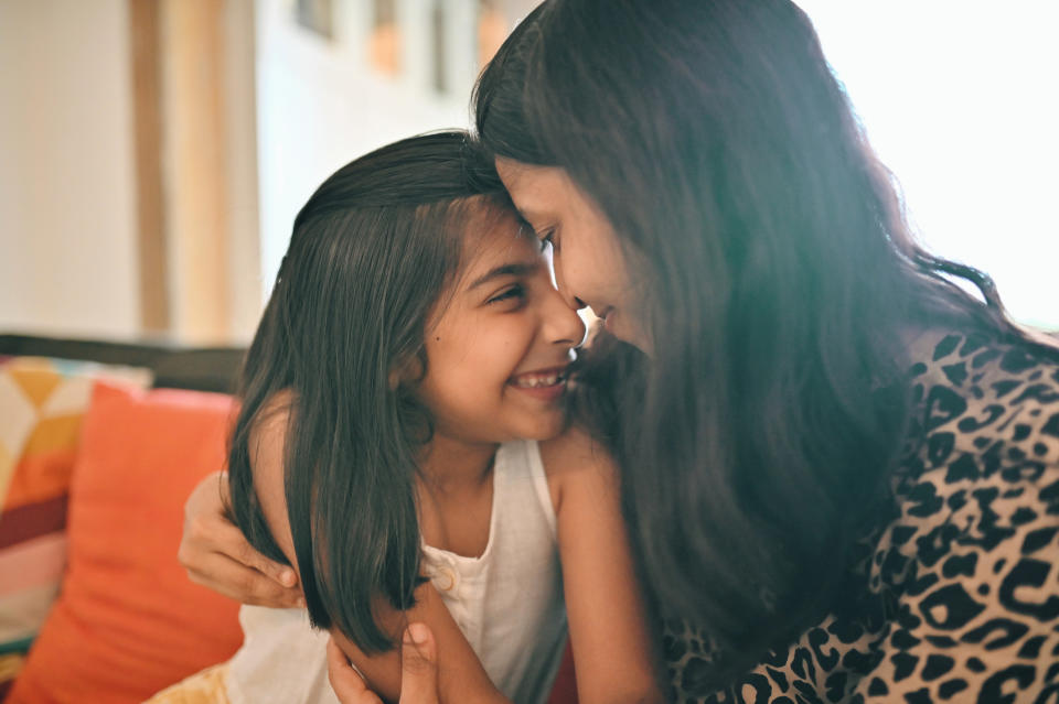 a woman cuddling her daughter