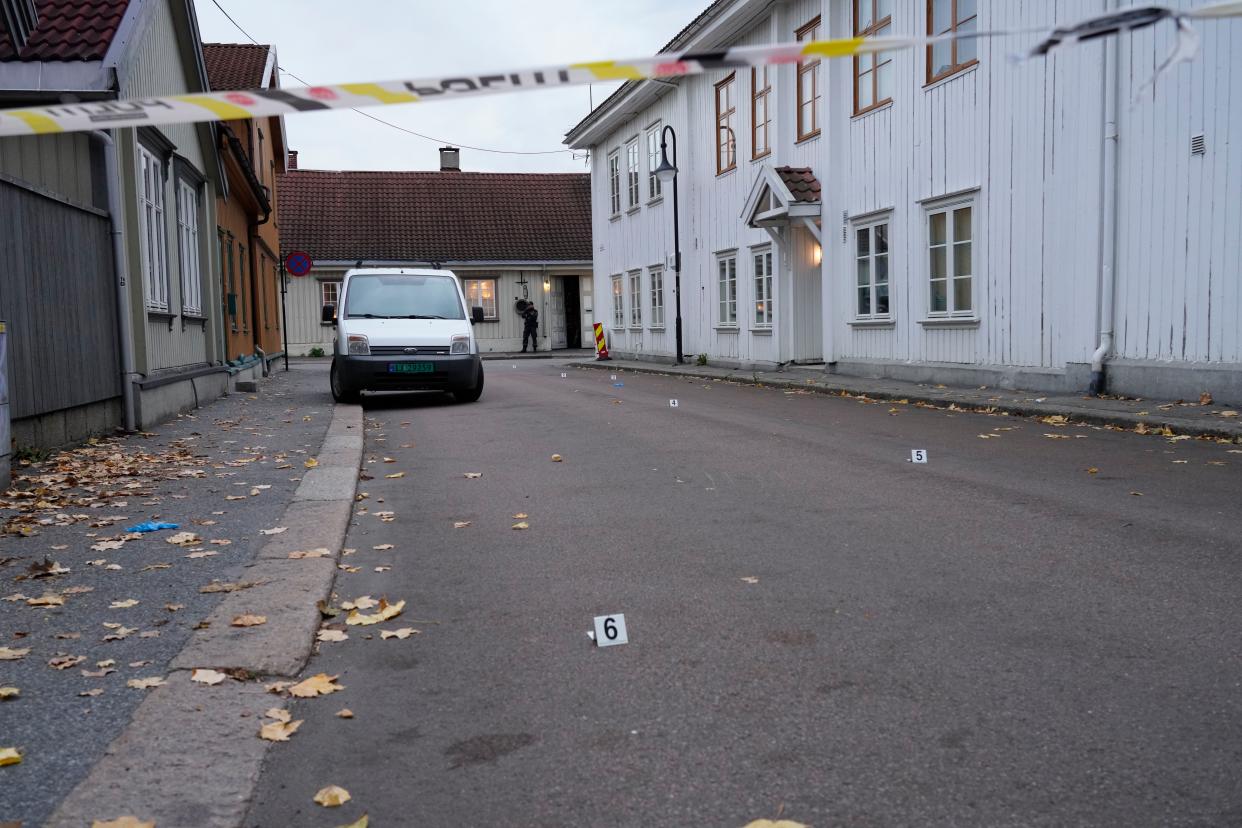 Police work near a site after a man killed several people, in Kongsberg, Norway, Thursday, Oct. 14, 2021. Police in Norway are holding a 37-year-old man from Denmark suspected in a bow-and-arrow attack in a small town that killed five people and wounded two others.