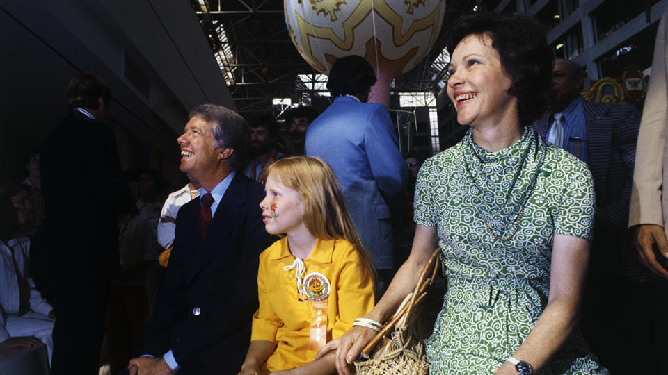 Jimmy Carter, Wife, and daughter Amy watch a puppet show at an Atlanta amusement complex in June 1976