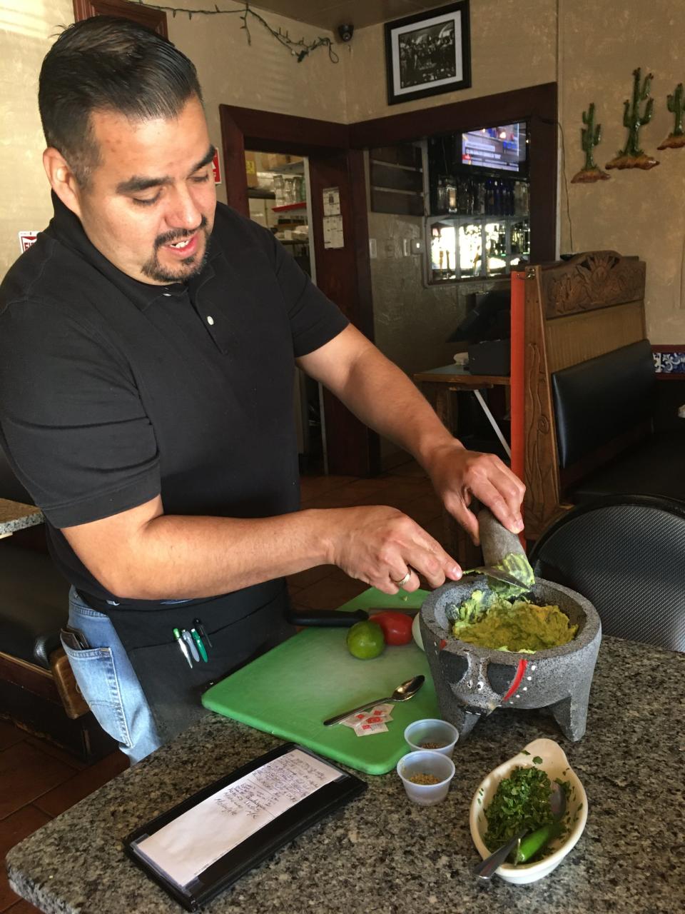 Emmanuel Martinez, owner of the Mexican Grill in Killingly, mixes up a batch of guacamole.