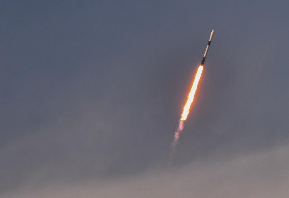 A SpaceX Falcon 9 rocket carrying 23 Starlink satellites rises into the sky Sunday night from Cape Canaveral Space Force Station.