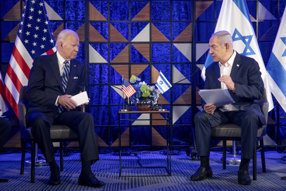 FILE - U.S. President Joe Biden, left, meets with Israeli Prime Minister Benjamin Netanyahu, right, to discuss the the war between Israel and Hamas, in Tel Aviv, Israel, on Oct. 18, 2023. U.S. and Mideast mediators appeared optimistic in recent days that they are closing in on a deal for a two-month cease-fire in Gaza and the release of over 100 hostages held by Hamas. But on Tuesday, Israeli Prime Minister Netanyahu rejected the militant group's two main demands — that Israel withdraw its forces from Gaza and release thousands of Palestinian prisoners — indicating that the gap between the two sides remains wide. (Miriam Alster/Pool Photo via AP, File)