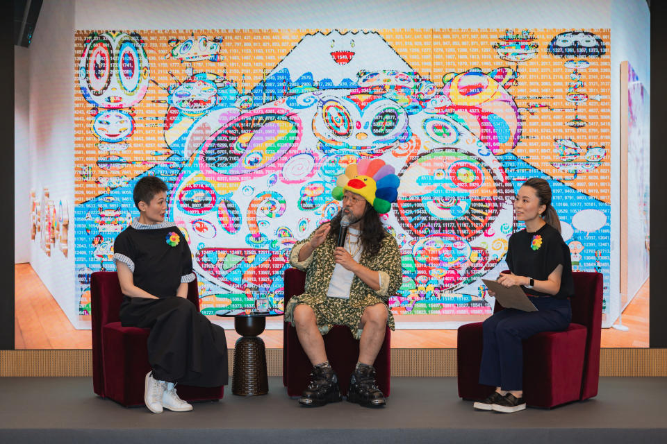 Takashi Murakami and curator and art adviser Adeline Ooi in conversation at Landmark, with a translator.