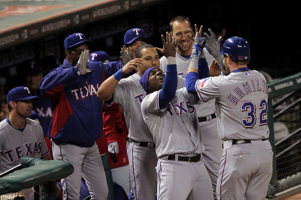 ST LOUIS, MO - OCTOBER 27: Josh Hamilton #32 of the Texas Rangers celebrates in the dugout with Esteban German #6, Yorvit Torrealba #8 and David Murphy #7 after hitting a two-run home run in the 10th inning during Game Six of the MLB World Series against the St. Louis Cardinals at Busch Stadium on October 27, 2011 in St Louis, Missouri. (Photo by Doug Pensinger/Getty Images)