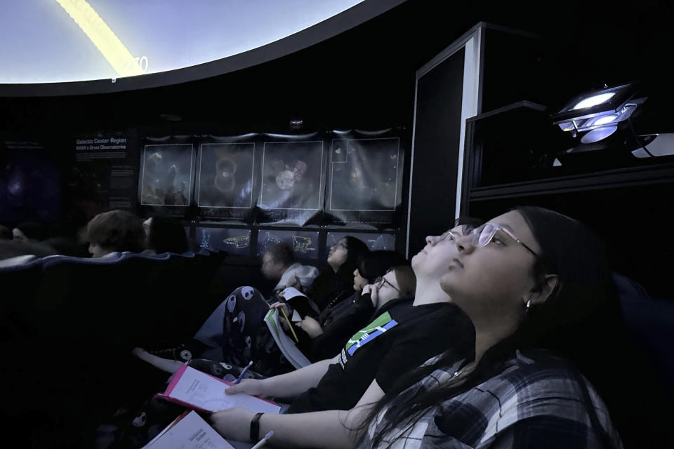 Students take in a lesson at the Williamsville North High School planetarium in Williamsville, N.Y., on March 18, 2024, in preparation for the upcoming total solar eclipse. Teachers in or near the path of totality say they have worked to come up with educational and engaging lessons for the rare event. (AP Photo/Carolyn Thompson)