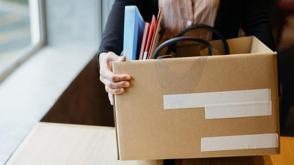 woman holding a box of her stuff