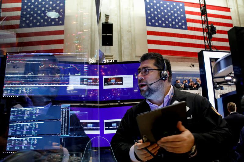 FILE PHOTO: A trader works on the floor of the NYSE in New York