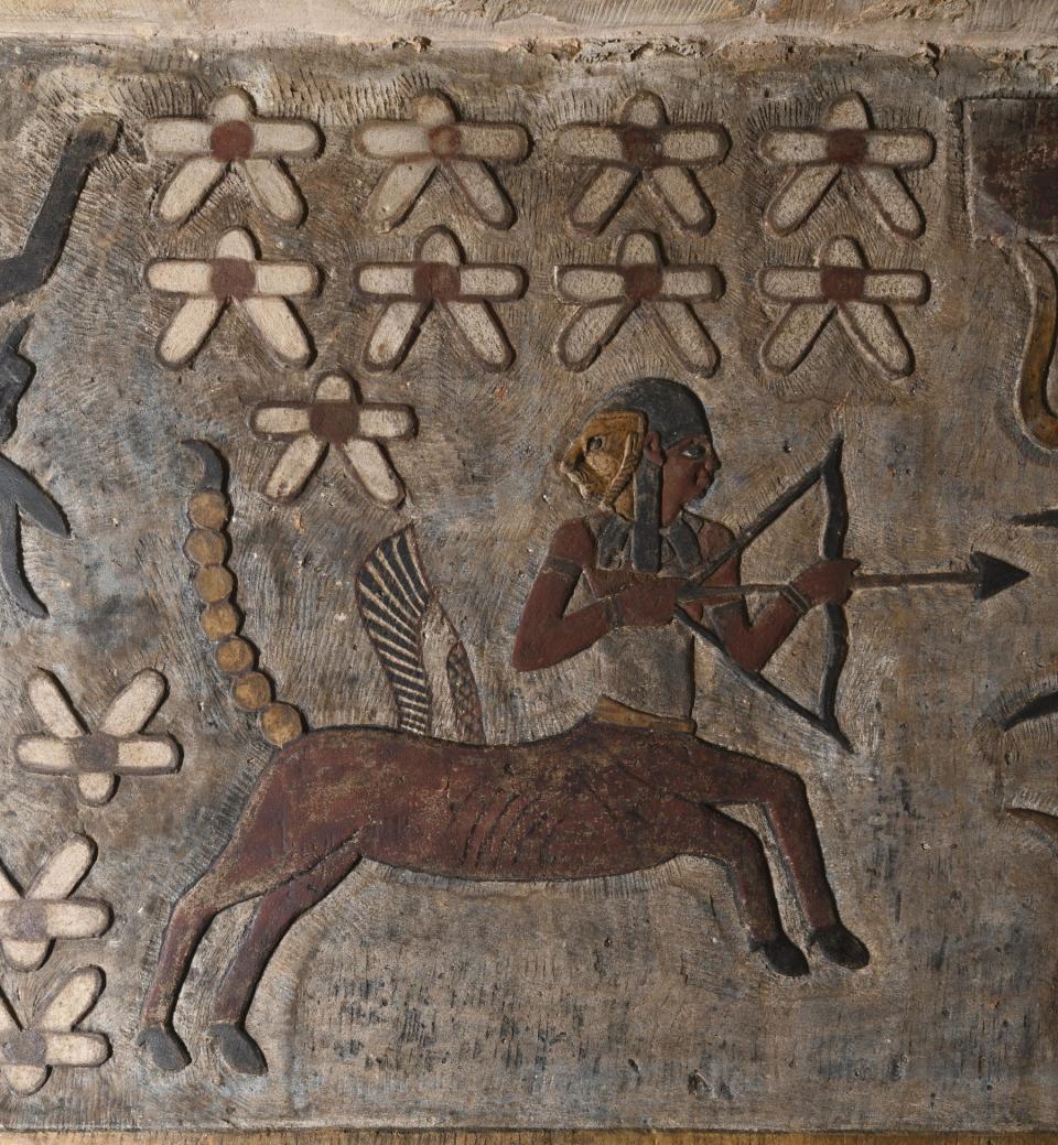 A painting shows a zodiac, which seems to combine the characteristics of a horse, a scorpio tail, wings of a bird, and torso of a man holding a bow. This is an ancient Egyptian symbol for the Sagittarius.