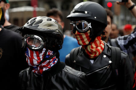 Masked conservative demonstrators are seen during a Patriots Day Free Speech Rally in Berkeley, California, U.S., April 15, 2017. REUTERS/Stephen Lam