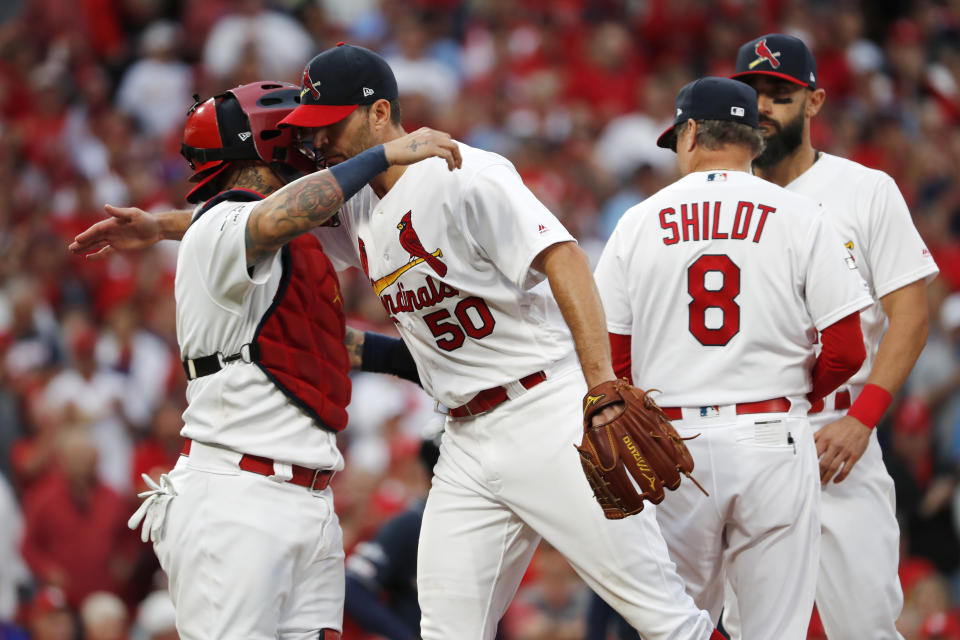 St. Louis Cardinals starting pitcher Adam Wainwright (50) gets a hug from catcher Yadier Molina, left, after being removed during the eighth inning in Game 3 of a baseball National League Division Series against the Atlanta Braves, Sunday, Oct. 6, 2019, in St. Louis. (AP Photo/Jeff Roberson)
