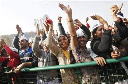 Supporters of Aam Aadmi (Common Man) Party (AAP) cheer after its leader Arvind Kejriwal took an oath as the new chief minister of Delhi during a swearing-in ceremony at Ramlila ground in New Delhi December 28, 2013. REUTERS/Anindito Mukherjee