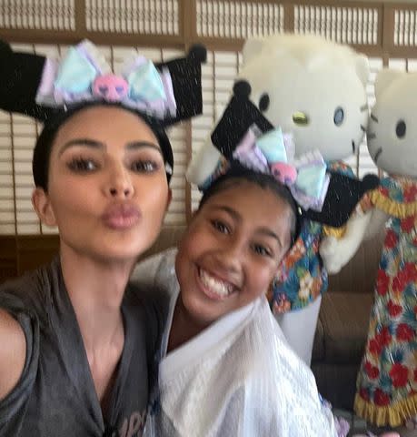 <p>Kim Kardashian/Instagram</p> Kim Kardashian and North West pose in front of life-size Hello Kitty dolls during their recent trip to Japan.