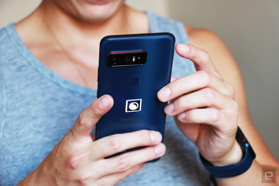 A man holding the Smartphone for Snapdragon Insiders. The picture shows the phone in his hands, with its rear facing us.