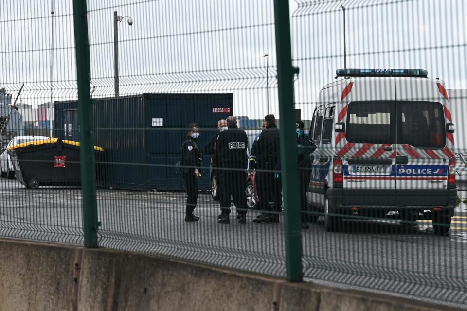 Police officers stand near a police car at Dunkerque port, northern France: AFP via Getty Images