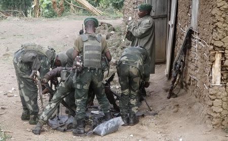 Congolese soldiers from the Armed Forces of the Democratic Republic of Congo (FARDC) assemble their ammunition during their offence against the rebels from the Democratic Forces for the Liberation of Rwanda (FDLR) in Kirumba village of Rutshuru territory in eastern Democratic Republic of Congo, February 28, 2015. REUTERS/Kenny Katombe