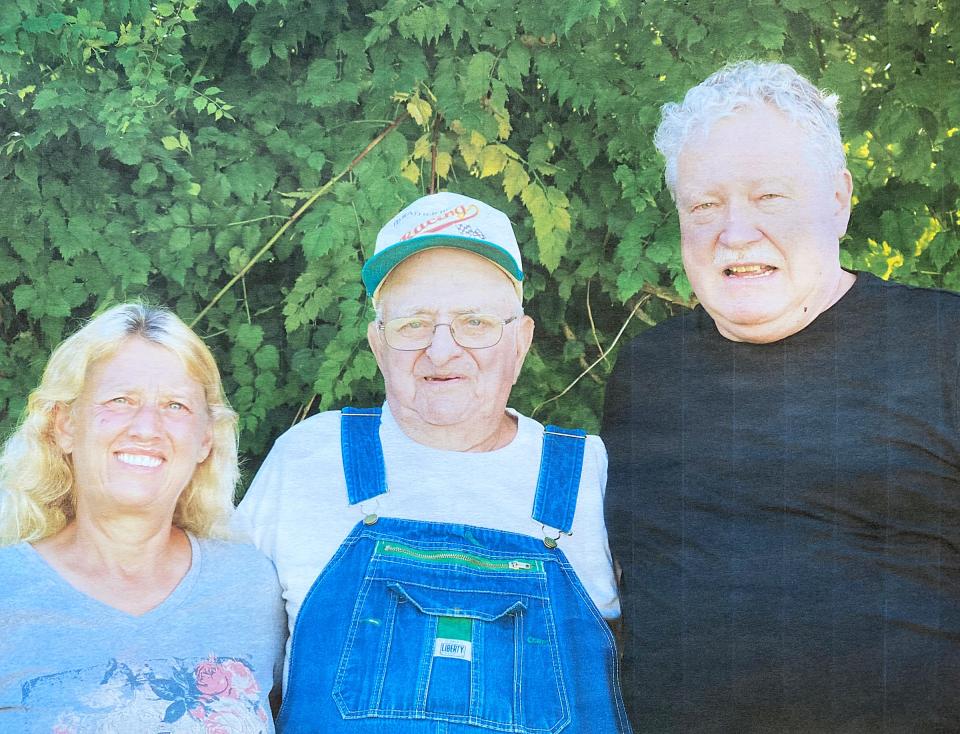 Eldon Schrader poses for a photo with Fred Otterbein and his daughter, Laurie.