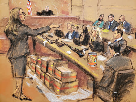 Assistant U.S. Attorney Andrea Goldbarg points at Mexican drug lord Joaquin "El Chapo" Guzman (back row C) in this courtroom sketch during Guzman's trial in Brooklyn federal court in New York City, U.S., January 30, 2019. REUTERS/Jane Rosenberg