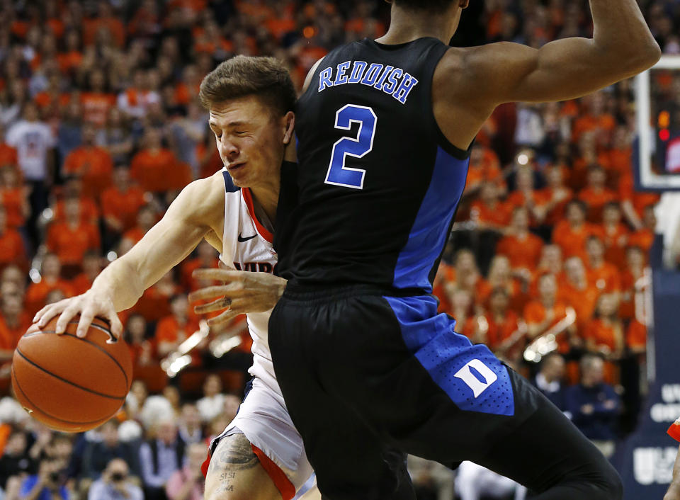 Virginia's Kyle Guy is fouled by Duke's Cam Reddish (2) during the second half of an NCAA college basketball game in Charlottesville, Va., Saturday, Feb. 9, 2019. (Mark Gormus/Richmond Times-Dispatch via AP)