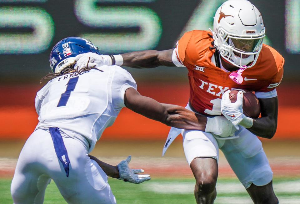 Texas Longhorns wide receiver <a class="link " href="https://sports.yahoo.com/ncaaf/players/328067" data-i13n="sec:content-canvas;subsec:anchor_text;elm:context_link" data-ylk="slk:Xavier Worthy;sec:content-canvas;subsec:anchor_text;elm:context_link;itc:0">Xavier Worthy</a> (1) looks for room to run after the catch against Rice Owls cornerback Sean Fresch (1) in the first half of an NCAA college football game, Saturday, Sept. 2, 2023, in Austin, Texas.