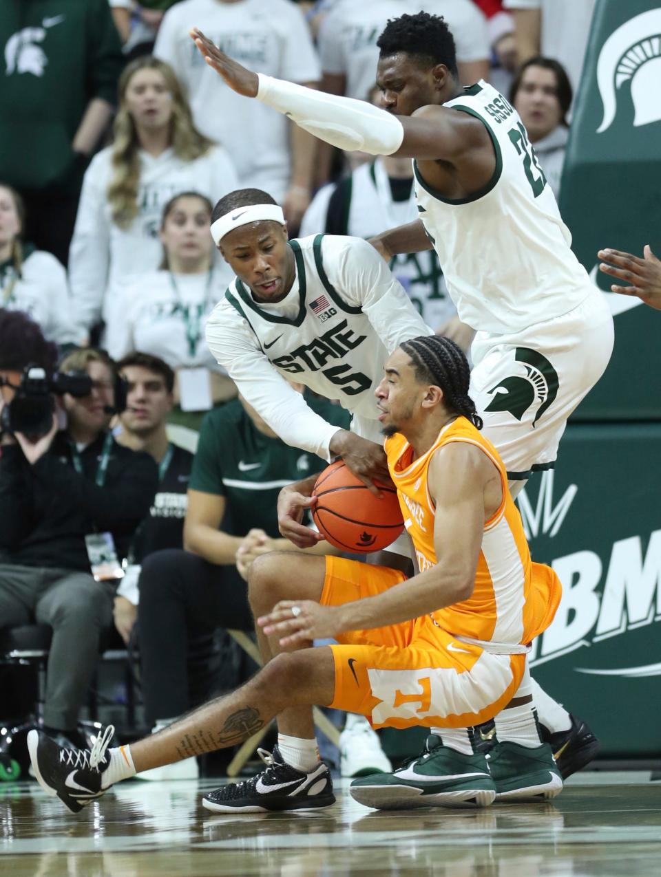 Michigan State Spartans guard Tre Holloman (5) and center Mady Sissoko (22) defend against Tennessee Volunteers guard Freddie Dilione V (1) during second-half action at Breslin Center in East Lansing on Sunday, Oct. 29, 2023.