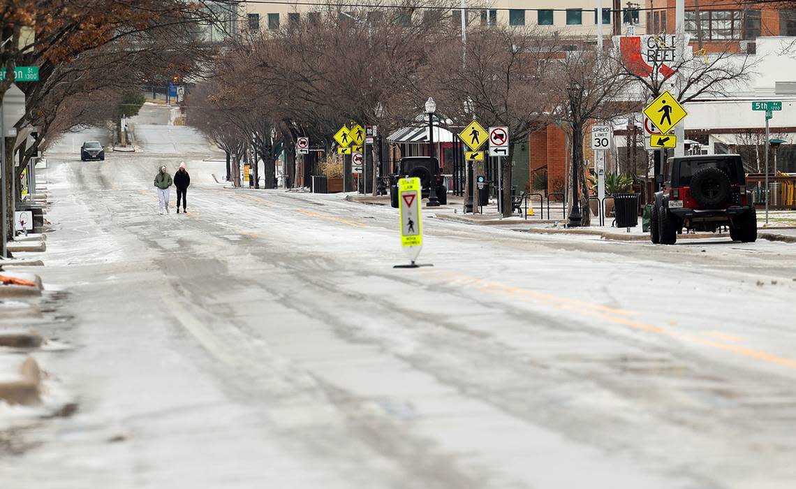 Pedestrians make their way on a melted section of Magnolia Street on Wednesday, February 1, 2023. Tarrant, Dallas and 20 other North Texas counties were under an ice storm warning until 9 a.m. Thursday, according to the National Weather Service.