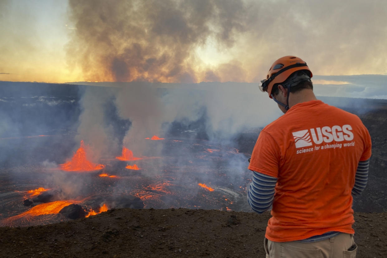 A staff member with the U.S. Geological Survey monitors the eruption.