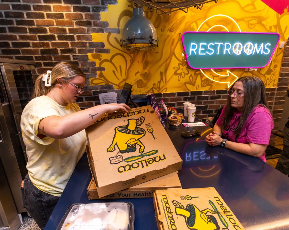 Frieda Aleman, left works the to-go counter on Dec. 4, opening day for Mellow Mushroom Ocala, 2 SW Fort King St.