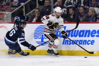 Chicago Blackhawks' Erik Gustafsson (56) skates away from Winnipeg Jets' Jacob Cederholm (78) during the second period of an NHL hockey game Sunday, Feb. 16, 2020, in Winnipeg, Manitoba. (Fred Greenslade/The Canadian Press via AP)