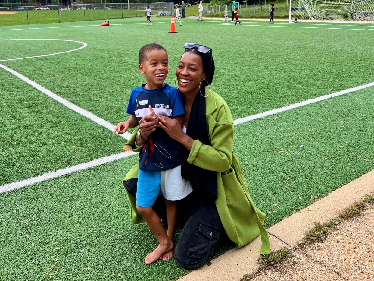 Mom and son standing in soccer field